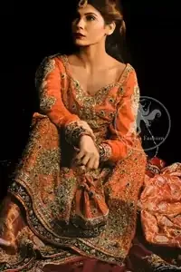 Fully embellished rust pure chiffon shirt. Pure brocade (Kamkhab) sharara with an embroidered border at the bottom. The maroon pure chiffon dupatta has a four-sided embroidered border. Motif spray scattered all over the sharara and dupatta.