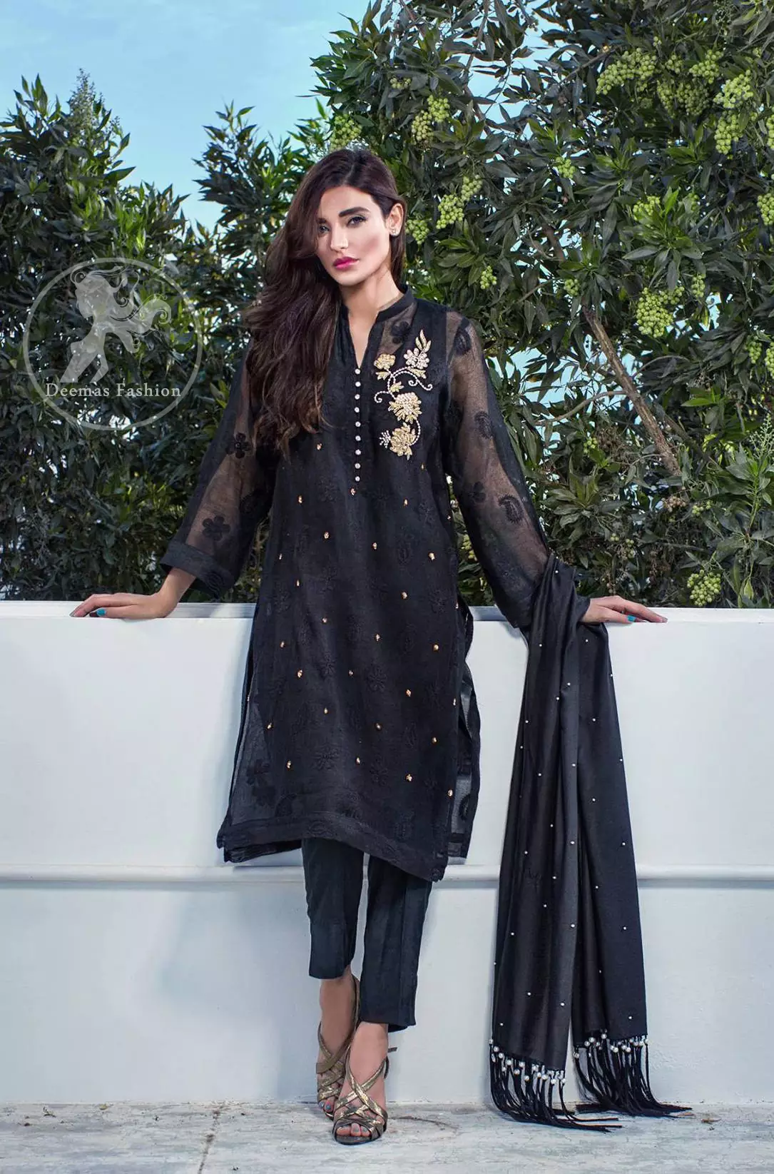 The black embroidered chiffon straight shirt has embroidered motifs which have been implemented on the shirt. 