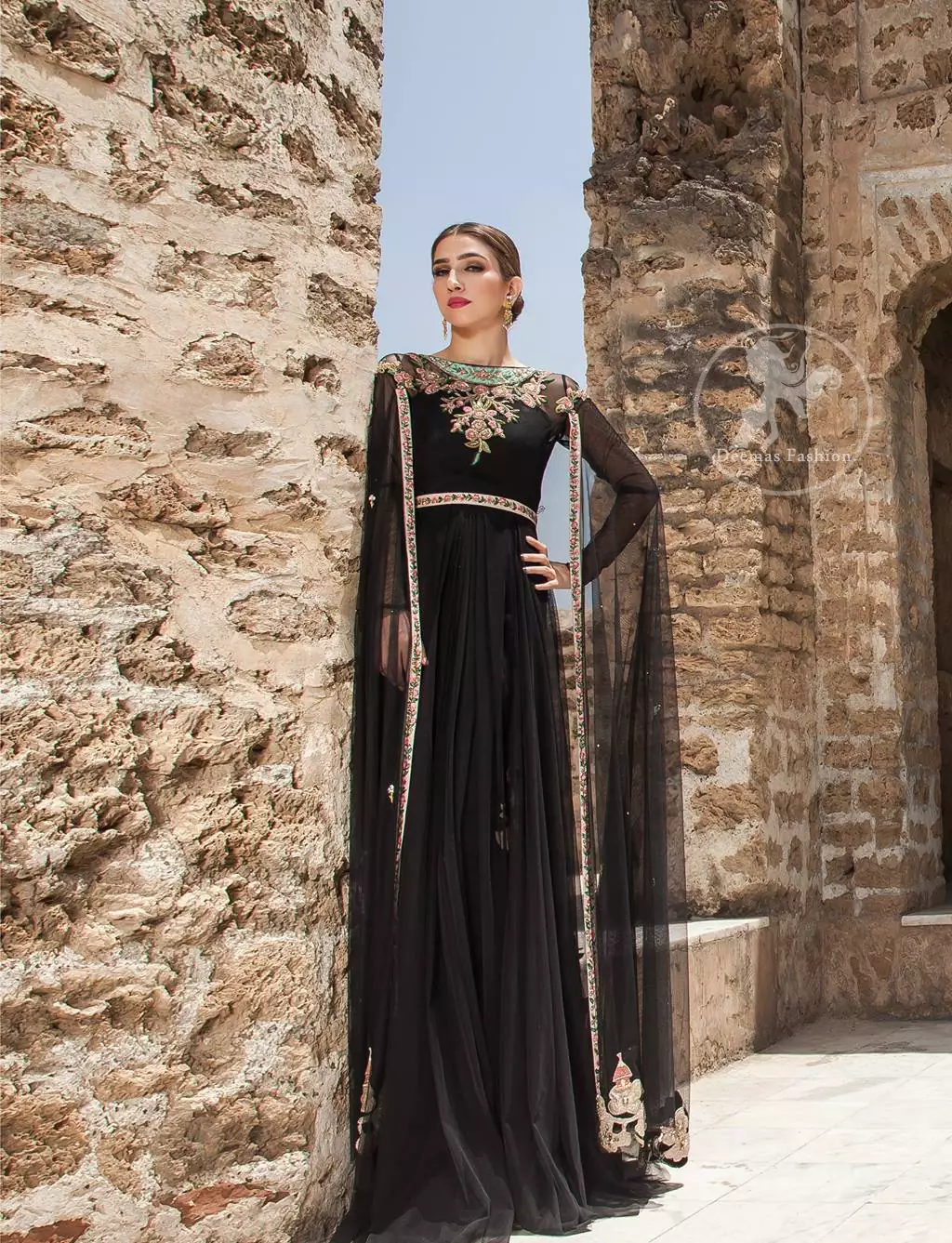 Black Party Wear Maxi. Embroidered borders are implemented on front slits. Flared maxi features beautiful and fabulous embellishments on the neckline.