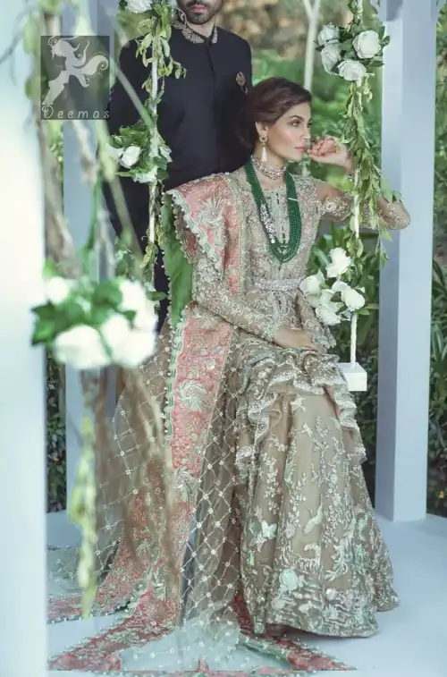 Fawn short length peplum made with net having embellished belt on waist. Large embellished border having peach appliqued on dupatta.