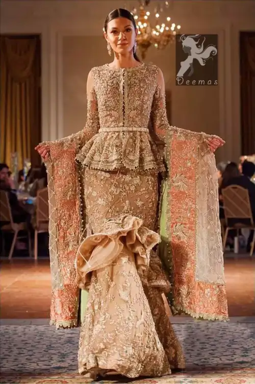 Fawn short length peplum made with net having embellished belt on waist. Large embellished border having peach appliqued on dupatta.