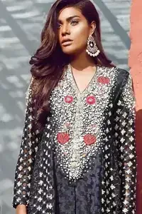 Black peplum made with pure banarsi jamawar chiffon. Peplum having multiple panels of different banarsi patterns. White and silver embellishment on neckline, side panels and sleeves. Pure raw silk sharara pants.