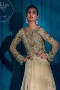 Ivory floor length Anarkali embellished with floral embroidery. Front and back bodice is fully embroidered with dull golden and antique shades of kora, dabka, tilla, pearls and sequins. There is beautiful cutwork and embroidery on sleeves cuffs and near the shoulders. Its hemline is allured with two delicate appliqued borders. One of them is of white pearls and the other one is of delicate embroidery.  This dress is artistically coordinated with simple ivory brocade lehengha and delicate tissue dupatta. Dupatta is adorned with cutwork and embroidery on pallu and there is small floral embellishment pattern on dupatta.