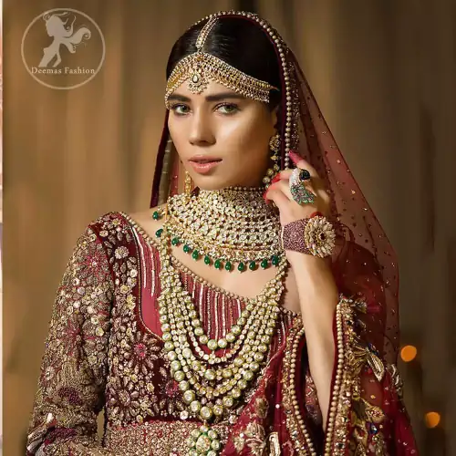 This maroon angrakha frock heavily embellished in the front with silver gold kora dabka, kundan and stones work. One side