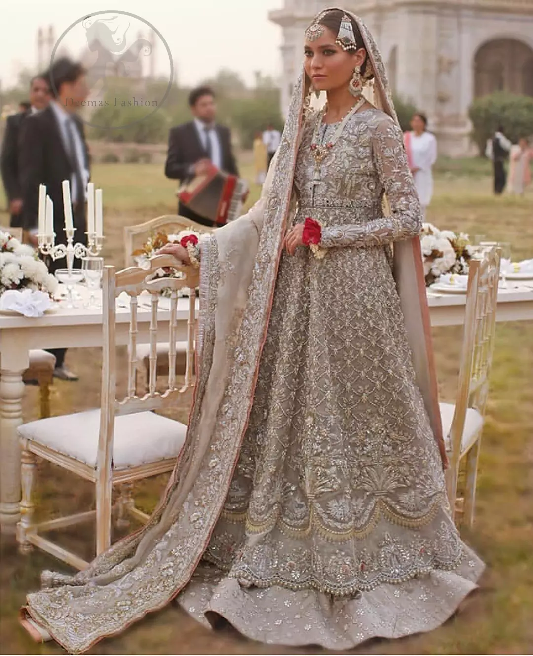 This outfit is a timeless beauty.It is heavily embellished with silver gold kora dabka, Sequins and swaronski crystals.This exquisite Pishwas is fully decorated with floral motifs patterns all over it.It is further enhanced with Foral thread embroidery.The trimming border of pishwas is ornamented with small golden pearls. It comes with embellished lehengha which has small sized sprinkled floral motifs all over.This Outfit is beautifully coordinated with matching Dupatta with heavy embroidered borders.