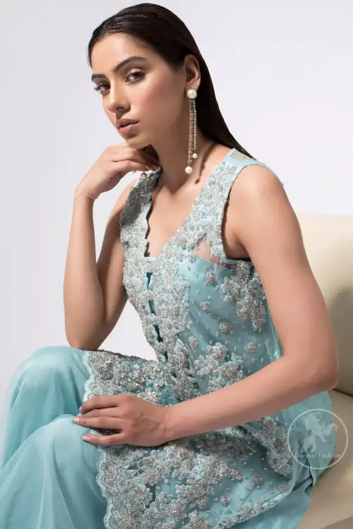 This classic shadow green shirt, meticulously highlighted with silver kora, dabka, tilla, sequins and pearls. This dress is adorned with