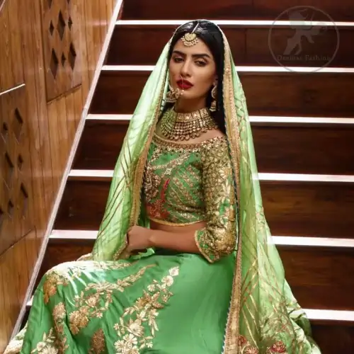 This outfit is embellished with gotta lace. It is meticulously highlighted with kora dabka, tilla, sequins and pearls. Sleeves are