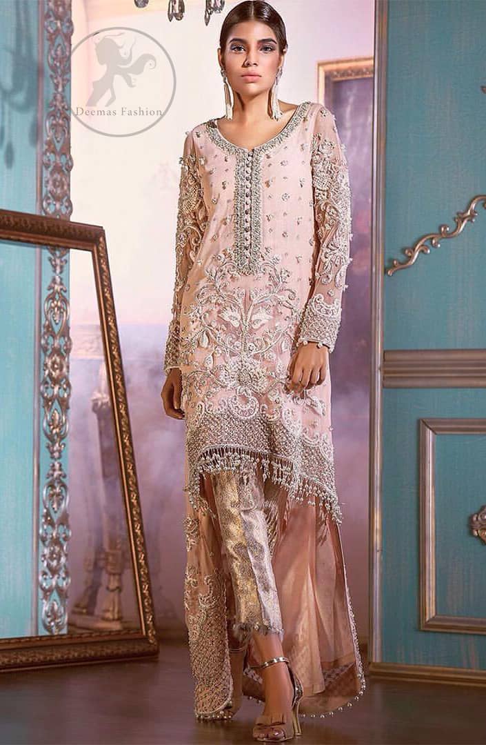 This outfit is decorated with silver kora, dabka, tilla, sequins and pearls. This dress is embellished with floral embroidery and intricate embroidered hemline. It is adorned with beautiful tassels which adds to the look. Sleeves are fully embellished. Trail is also embellished. It comes with brocade pajama. It is coordinated with chiffon dupatta which is sprinkled with sequins all over it.