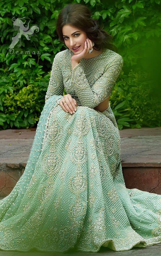 This dress is beautifully sculptured with floral embroidery.It is meticulously highlighted with dull golden and silver shaded kora, dabka, tilla, sequins and pearls. Full sleeves blouse is allured with embroidery. Waistline is adorned with swarovsky. It comes with net dupatta having sprinkled sequins all over it. It is coordinated with fully embellished lehengha.