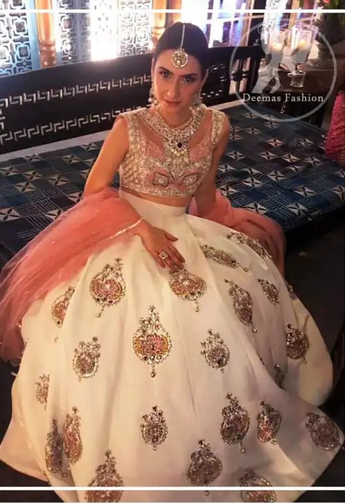 The blouse is beautifully embellished with cutwork embroidery enhanced with silver gold kora dabka, kundan and sequins work. It is