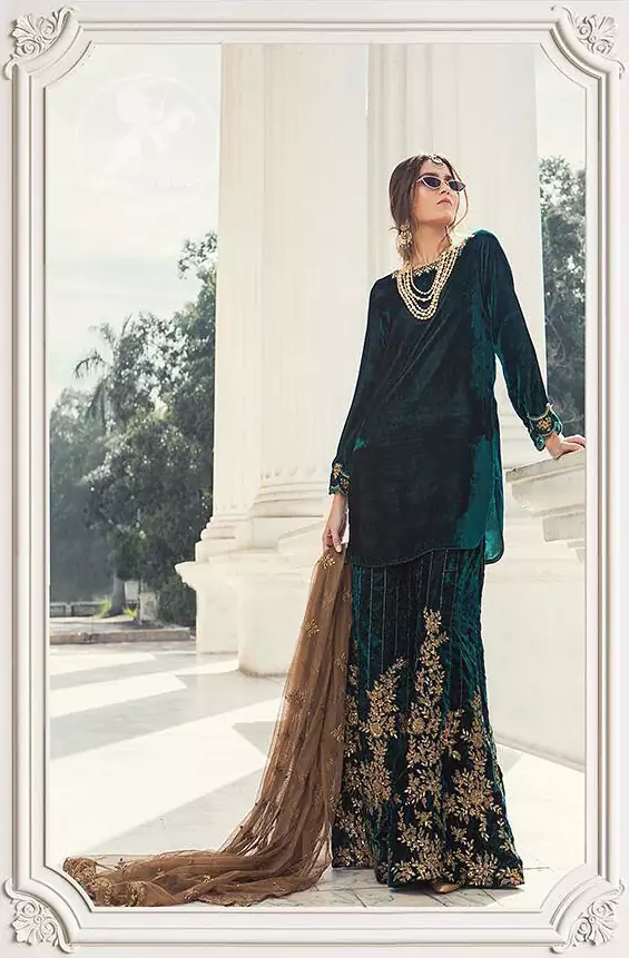 Take a step towards refreshing your wardrobe with bottle green velvet Shirt. The shirt is perfected with delicate gold tilla work. Add this bottle green velvet golden embellished bell bottom for a complete look. It comes with golden net dupatta enhanced with small motifs on the ground.