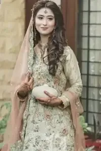 Exude elegance and class in this tissue shirt finessed with beautiful embellishment. The shirt is delicately ornamented with multiple colored zardozi work. Daman of the shirt is enhanced with hand-embroidered lace. It comprises with antique brass sharara adorned with thick embellished borders and sprinkled sequins. It is coordinated with an antique brass dupatta with embellished borders on the length of the dupatta.