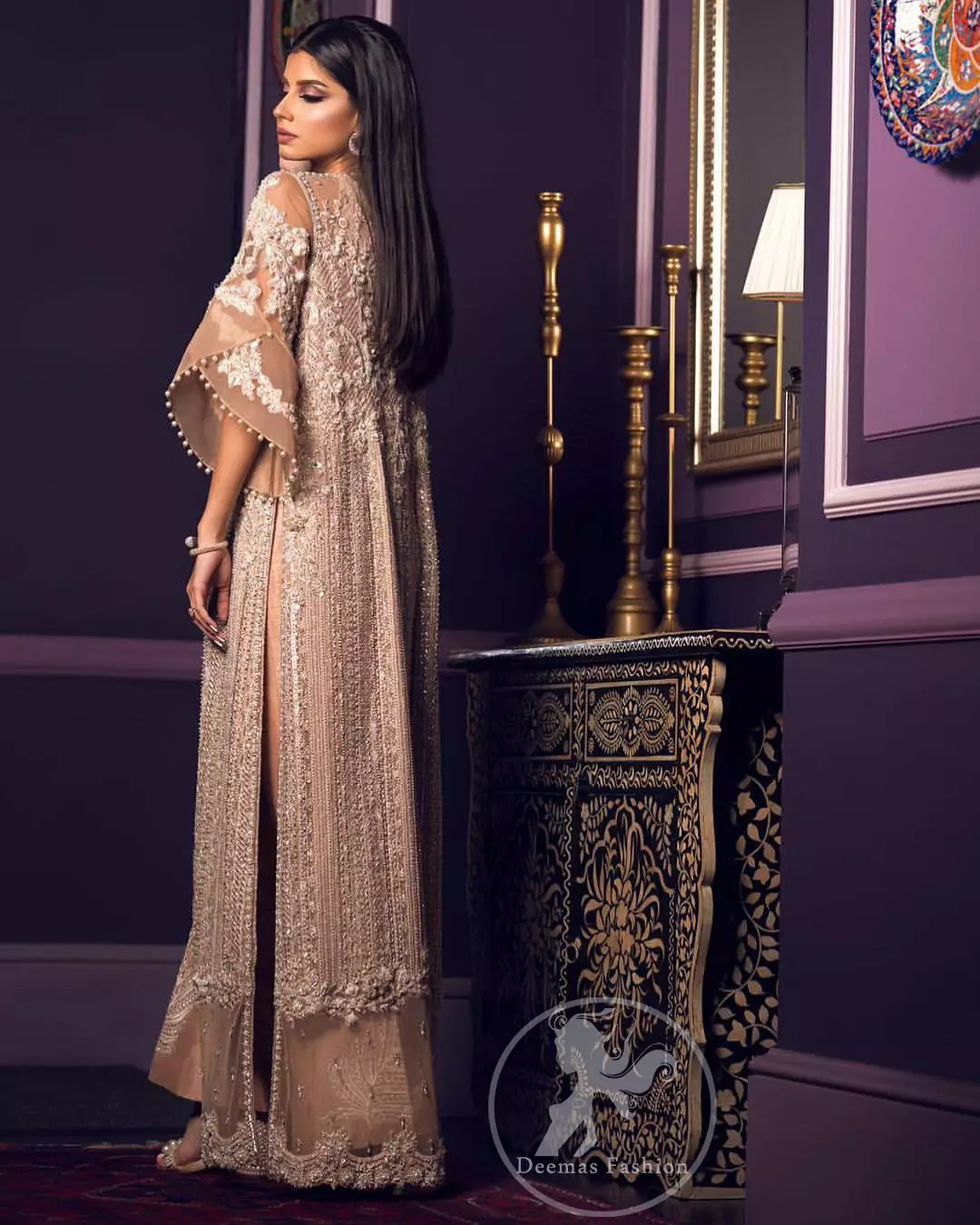This dress is decorated with floral embroidery. It is highlighted with kora, dabka, tilla, sequins and pearls. Gown is adorned with scalloped border and tassels which adds to the look. It comes with trousers. It is coordinated with organza dupatta which is sprinkled with sequins all over it.