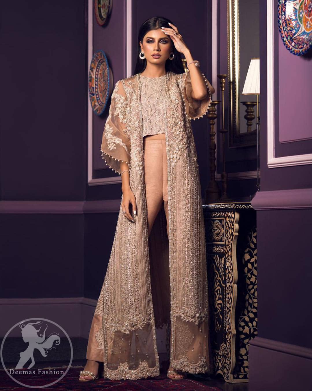 This dress is decorated with floral embroidery. It is highlighted with kora, dabka, tilla, sequins and pearls. Gown is adorned with scalloped border and tassels which adds to the look. It comes with trousers. It is coordinated with organza dupatta which is sprinkled with sequins all over it.