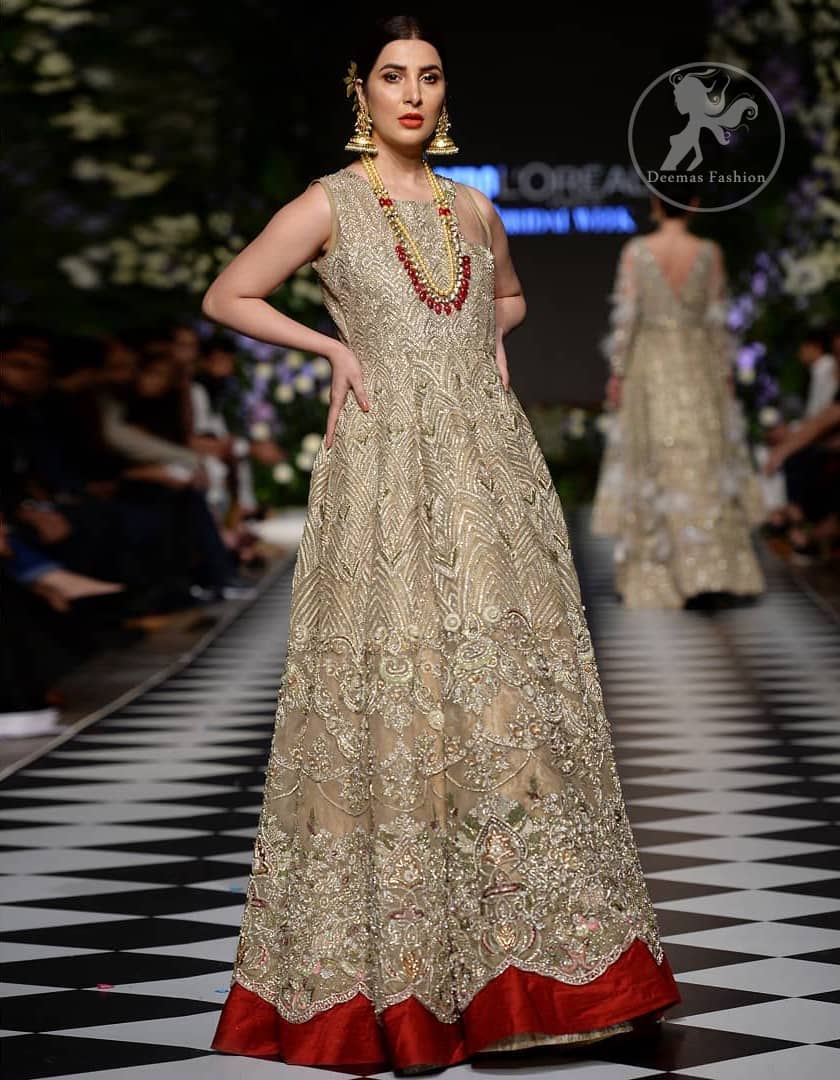 Delicately crafted and personifying chic elegance with an element of grandiose. This dress is beautifully sculptured with floral embroidery, adorned with cutwork borders embellished with dull gold and silver kora, dabka, pearl and sequins work all over. Moreover it is enhanced with different styles multiple colored embroidered motifs and finished with marron applique. This outfit comes with brocade pajama. It is coordinated with tissue dupatta which is sprinkled with sequins all over it.