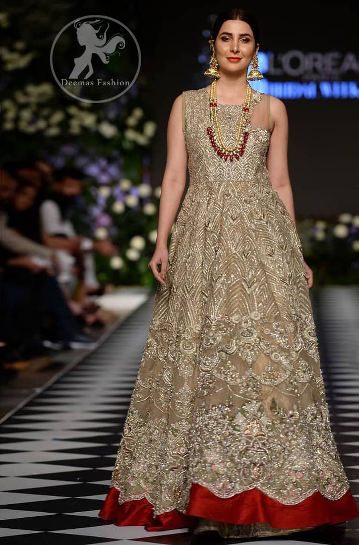 Delicately crafted and personifying chic elegance with an element of grandiose. This dress is beautifully sculptured with floral embroidery, adorned with cutwork borders embellished with dull gold and silver kora, dabka, pearl and sequins work all over. Moreover it is enhanced with different styles multiple colored embroidered motifs and finished with marron applique. This outfit comes with brocade pajama. It is coordinated with tissue dupatta which is sprinkled with sequins all over it.