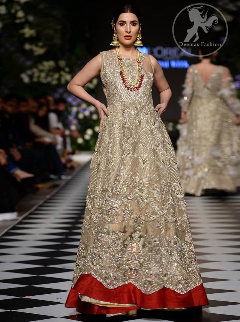 Delicately crafted and personifying chic elegance with an element of grandiose. This dress is beautifully sculptured with floral embroidery, adorned with cutwork borders embellished with dull gold and silver kora, dabka, pearl and sequins work all over. Moreover it is enhanced with different styles multiple colored embroidered motifs and finished with marron applique. This outfit comes with brocade pajama. It is coordinated with tissue dupatta which is sprinkled with sequins all over it.