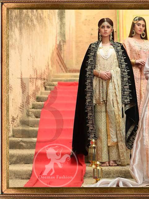 This outfit is beautifully sculptured with floral embroidery. It is further enhanced with kora, dabka, tilla, sequins and pearls. The daaman is emphasized with intricate details that gives perfect ending to this peplum. It is coordinated with straight trousers embellished with embroidery. The banarsi jamawar dupatta has scattered sequins all over. It is finished with jamawar piping all around the edges. It is allured with black embroidered shawl which adds to the look.
