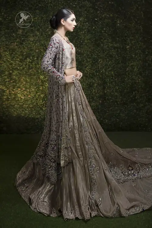 This bridal dress is beautifully decorated with floral embroidery. Gown is allured with floral embroidery and embellished scalloped border. It