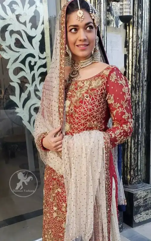 Make a dazzling impression in our zari embroidered copper rust shirt enhanced with intricately embellishmentswith gold and antique gold kora,