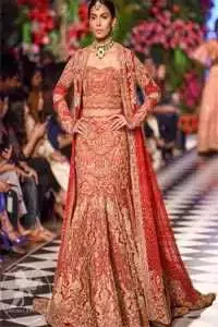 This dress is beautifully decorated with heavy embroidery. It is highlighted with dull golden kora, dabka, tilla, sequins and pearls. Fish lehengha is fully embellished.Blouse is scalloped. It comes with beautifull upper gown, sprinkled with sequins all over it. It is coordinated with chiffon dupatta which is sprinkled with sequins all over it.