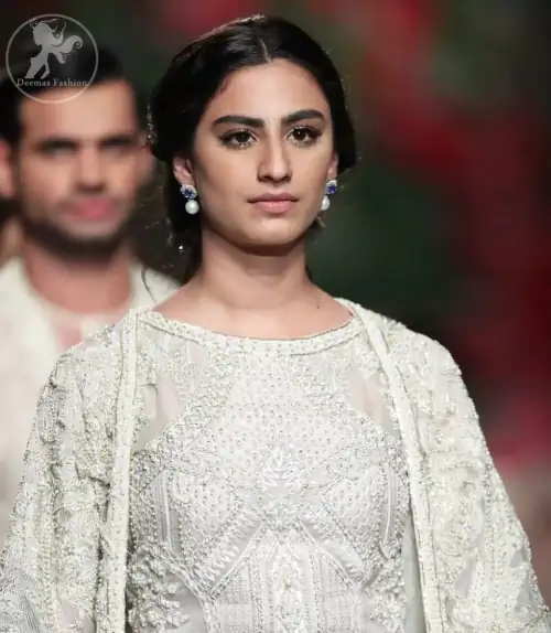 Go for this trendy dress. This dress is heavily embellished with floral and geometric styled embroidery decorated with silver kora,