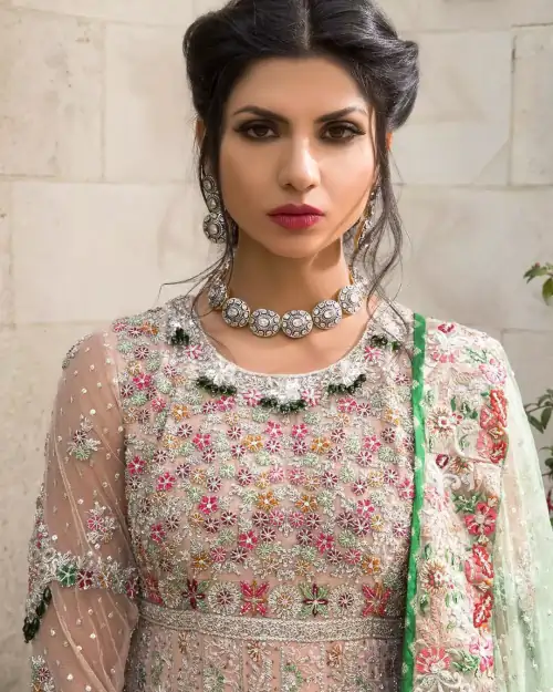 Opt for our ivory multiple-panel anarkali dress with exquisite embellishment on the bodice with pearls, sequins and silver kora, dabka.