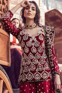 A beautiful short shirt heavily embellished with silver work enhanced with kora, dabka, tilla, sequins and stones. It is artistically coordinated with blue jamawar farshi gharara with floral embellished pattern at the bottom and finished with an appliqued embellished border. It is beautifully coordinated with jamawar dupatta sprinkled with small motifs andan appliqued border finished around dupatta.