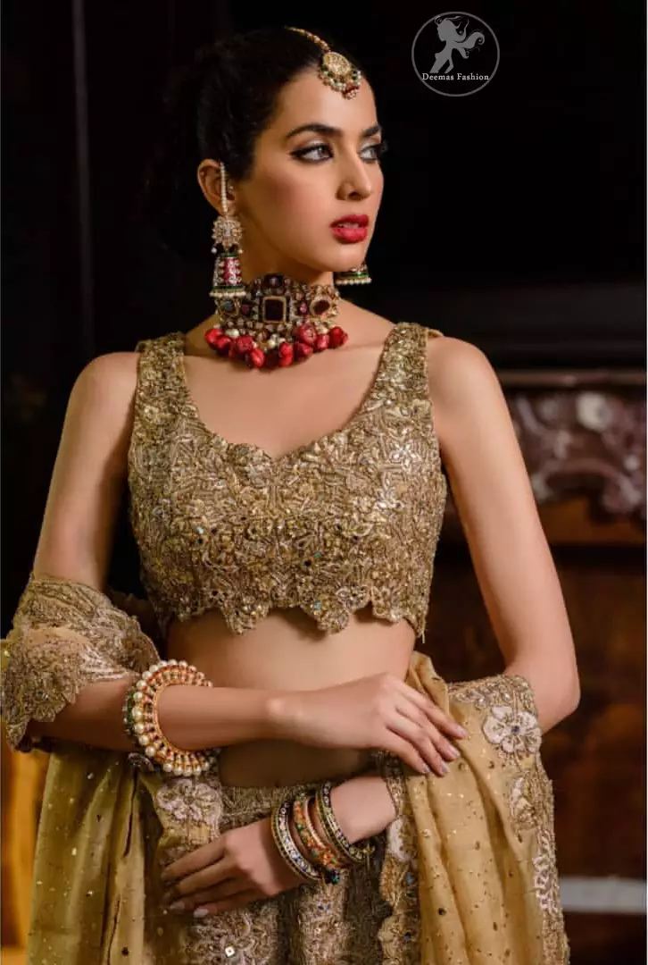This bridal dress is perfect for your special day. Blouse is beautifully decorated with floral embroidery and embellished scalloped border. It is adorned with kora, dabka, tilla, sequins and pearls. It comes with an exquisite lehengha with thick embroidered border to give it a regal look. Dupatta comprises of floral thread embroidery allured with thick embellished border