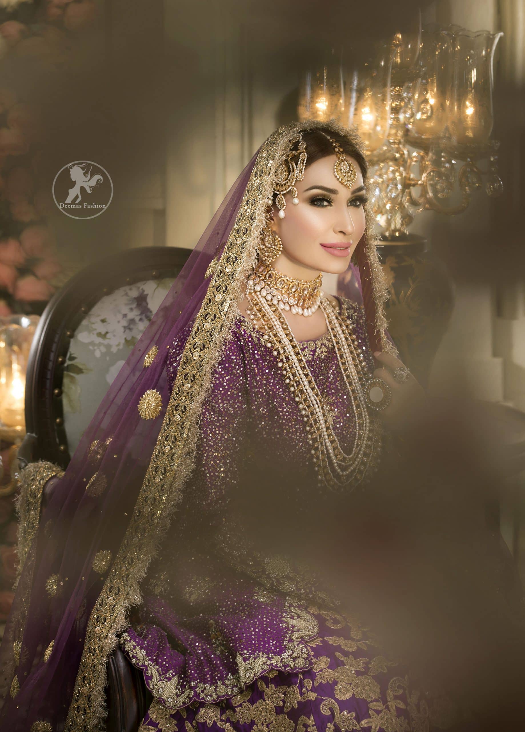 Reflecting royalty and the majestic beauty of statuesque shape and silhouette this bridal dress is perfect for your special day. This dress is beautifully decorated with heavy embroidery. It is highlighted with golden kora, dabka, tilla, sequins and pearls. The short shirt is decorated from neckline and scalloped hemline is decorated with zardosi work. Lehenga is enhanced with floral patterns all over with golden embellishment. It is coordinated with chiffon dupatta which is sprinkled with small floral motifs all over.