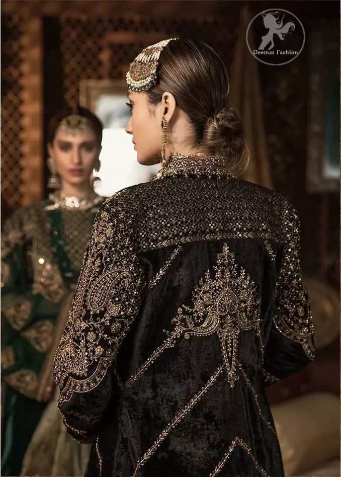 Steal the moment with our rangoon green gown emphasized with traditional and intricate floral embroidery enhanced with antique shaded kora, dabka, tilla and sequins. Perfected with antique gold embellishments this black velvet ensemble is timeless masterpiece in to a chic fantasy. It is fully decorated with antique shaded embroidery and floral motifs all over. Bottom is enhanced with bottle green velvet patch. paired up with floor length dark tan inner. It is coordinated with chiffon dupatta which is sprinkled with sequins all over it.