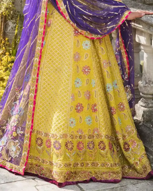 This dress is perfect for menhndi day. The shocking pink blouse is beautifully decorated with antique embroidery. It is highlighted
