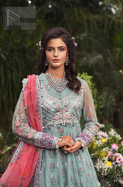 Gussy up in this luxuriously designed pishwas emboldened with intricate embroidery along with beautiful rich patterns and delicate details at the daaman. The front open jacket executing heavily hand crafted art of zardosi, kora and dabka with splashes of silver and pink floral motifs is a classical visit to feminine personification. Having full length sleeves adorned with floral bootis and lace details. It comprises with matching churidar pajama. Style it with self printed net dupatta having four sided thin border and dangling balls on all four sides.