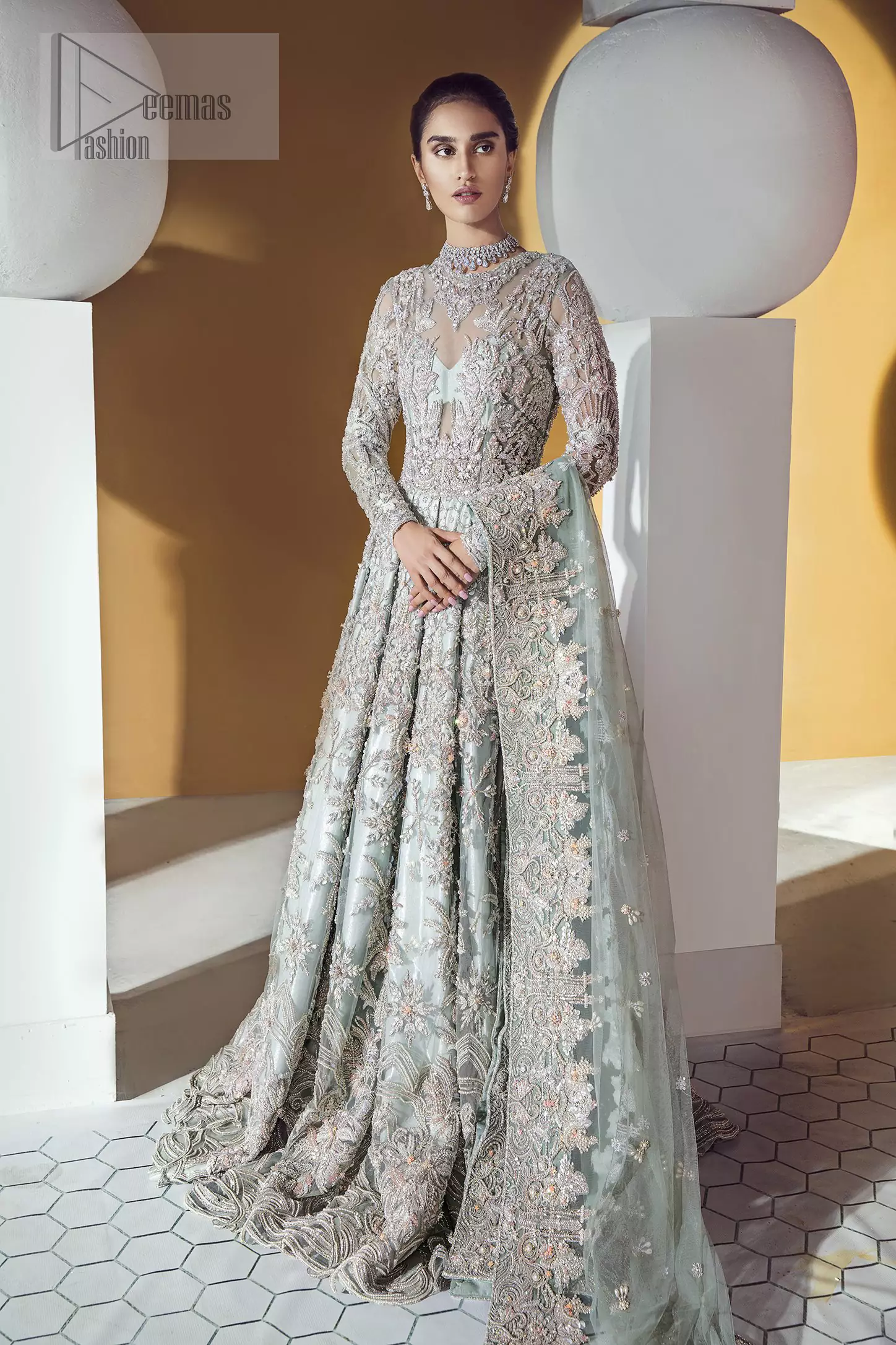 Furthermore this shirt is made of rich floral embroidery which is enhanced with zardoze work. It is highlighted with kora, dabka, tilla, sequins and pearls. It comes with brocade churidar pajama. It is coordinated with tissue dupatta which is sprinkled with sequins all over it.