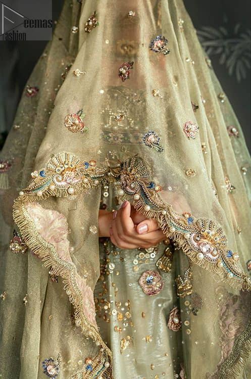This dress is perfect for your special day. This signature pishwas is crafted with organza featuring hand embroidery with elegant zardosi work. The bottom of the pishwas is enhanced with multiple color rich floral embroidery. The lehenga is timeless and elegant with a touch of modern trend,includes embroidery of kora, dabka, sequins and large floral motifs made up with multiple color resham threads. The dupatta incorporates beautifully designed borders on all four sides, focusing on the heavily embellished pallu borders to give it a perfect maharani look.