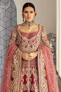 This heavenly handcrafted front open style bridal showcases the traditional art of zardozi, nakshi, kundan, kora and dabka; adorning the intricate and meticulous hand embellishments giving it a wholesome gentle stance paired with a regal gold and ivory lehenga. It comes with an exquisite lehenga with thick embroidered border to give it a regal look. Dupatta comprises of floral thread embroidery allured with thick embellished border.