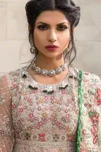 Opt for our ivory or peach multiple-panel frock dress with exquisite embellishment on the bodice with pearls, sequins and silver kora, dabka. The daaman comprises of borders highlighted with floral embellished pattern. It is finished with deep blush frilled lehenga which adds to the bling. Dupatta is allured with four sided embellished border and sprinkled with stones all over it.