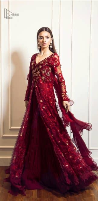 This exceptionally detailed front open gown lehenga is cut in a seductive fit and flare silhouette that’s sure to turn heads on your big day. The bodice with plunging V-neckline is adorned in richly floral lace with fabulous sparkle. Furthermore the bodice is highlighted with golden zardozi work and floral applique. Center slits and bottom of the gown is beautifully decorated with floral lace. It is coordinated with maroon crushed lehenga and organza dupatta. 