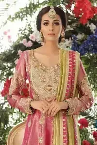 Nothing speaks of femininity and class louder than this mehndi outfits for bridesmaids. This beautiful mehndi dress comes with anarkali frock with beautiful embellished motifs around the scalloped hemline and vertically worked gold lines and heavily embellished neckline with light golden, champagne and antique shaded zardozi work. It comes with sharara adorned with colored floral embroidery with champagne embellishment. Complete the look with parrot green dupatta having four sided applique borders and sequins spray on the ground.