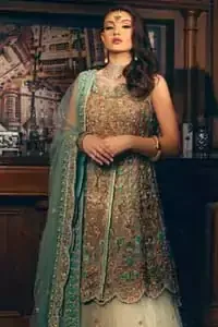 Classic, timeless and truly beautiful. Upholding the idea of simple is beautiful, you would definitely want to wear this outfit for your next occasion. The front open short frock is adorned with delicate arrangement of hand embellished floral patterns with multiple color thread embroidery and antique shaded zardozi work. The scalloped hemline done with champagne embellishment gives the right amount of glamour to the outfit. It coordinates with light fawn lehenga with scalloped bottom and heavy embellishment on it with zardozi. The look is completed with mint green organza dupatta with detailed work on the borders.