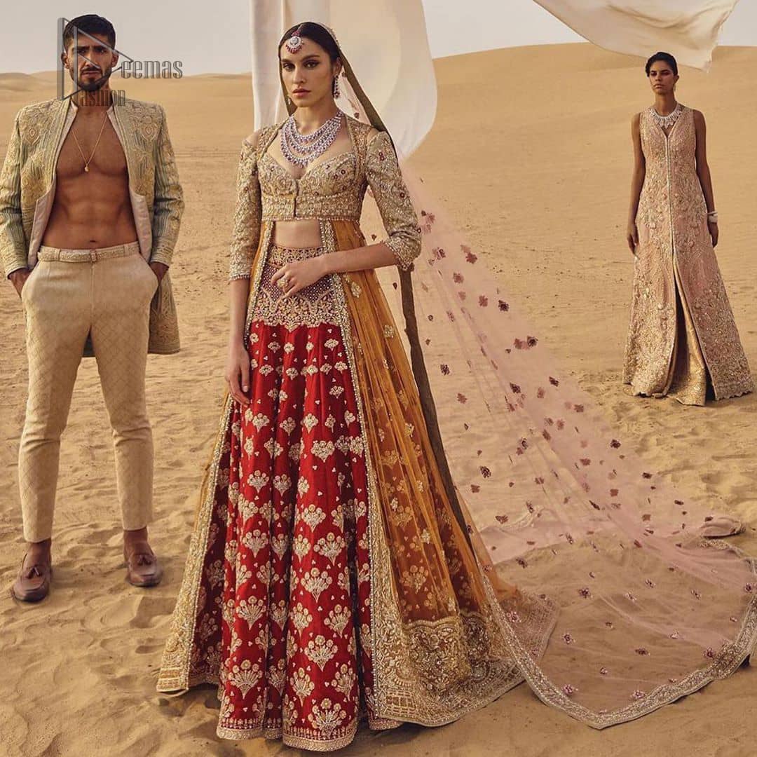 This weeding outfit makes a statement in this stunningly floraison, perfect blend of glamour and tradition with outstanding craftsmanship and gorgeous detailing. Heavily embellished blouse and bottom done with golden zardozi work and detailed central slits instantly draws attention. The lehnga with embroidered motifs spread all over and thick embellishment on lower waist. Paired it up with light pink net dupatta sprinkled with tiny motifs and four sided border.