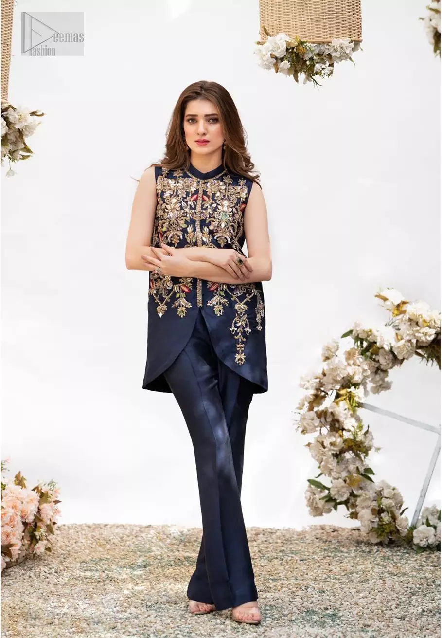 This outfit is timeless beauty. Boost your confidence and style in this glamorous attire accentuated with finest zardozi and thread work. The shirt is delicately handcrafted with golden zarozi work and multiple color thread embroidery. Style it up with navy blue bell bottom pants which complete the look.