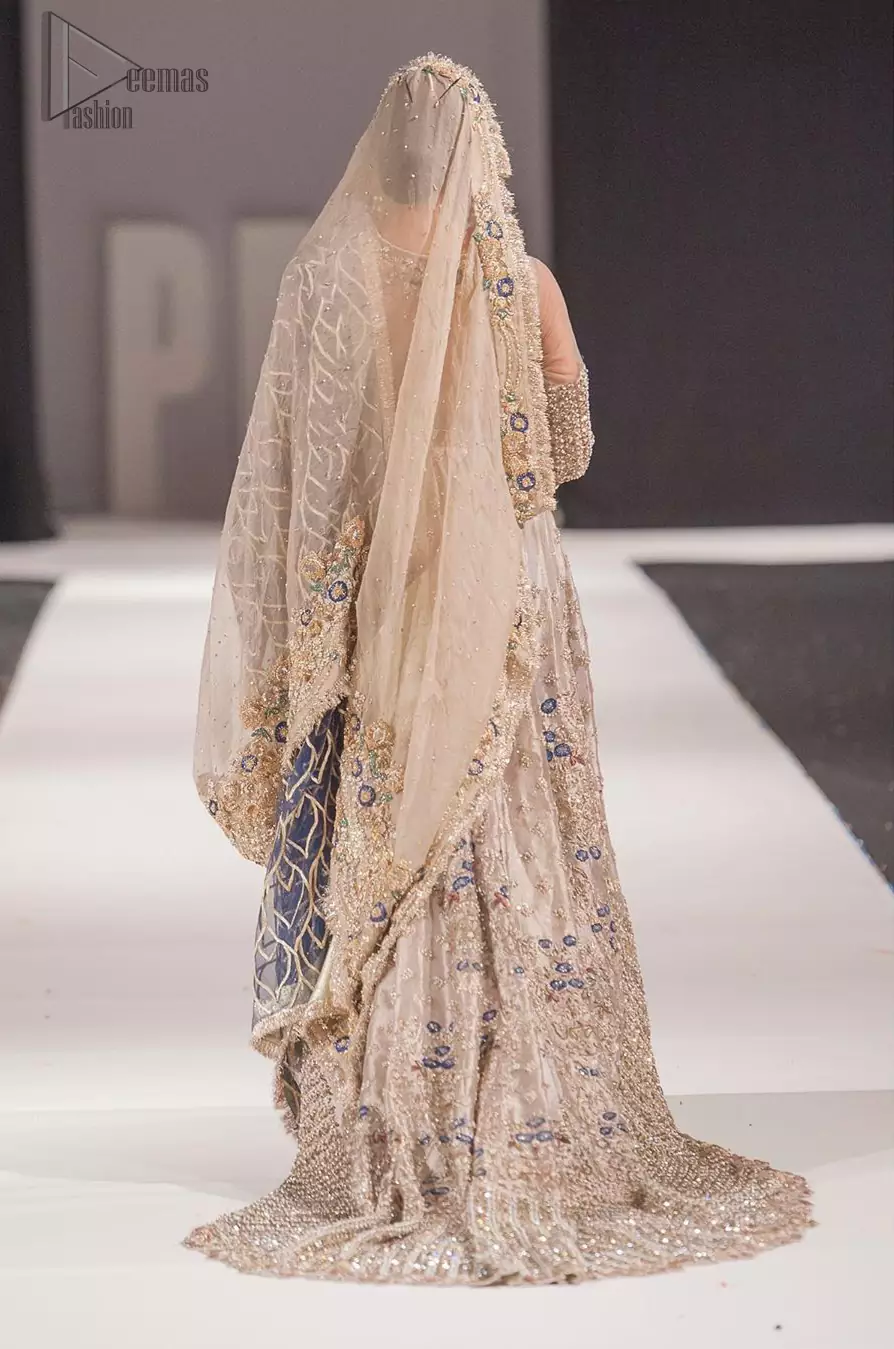 This artisan piece includes intricate hand-embellishment. This technique gives your garments a unique look, and helps to sustain a traditional craft carried out by skilled artisans across Asia. Adorned with dull golden zardozi and multiple color thread embroidery around the neckline and bodice. Furthermore the scalloped bottom is ornamented with floral jhaal, multiple color embellished floral bootis and tiny motif all over. Style it up with gray dupatta done with gotta work and cigarette pants.