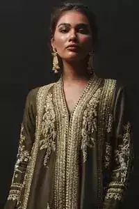 Discover your inner charm with this ravishing front open shirt adorned with golden embellishment. A delicate arrangement of hand embellished floral bunches with zardozi work. Full sleeves and side slits are also decorated with kora, dabka, tilla and sequins work all over. It is coordinated with frilled sharara gives it a perfect look. Style it up with olive green dupatta sprinkled with sequins.