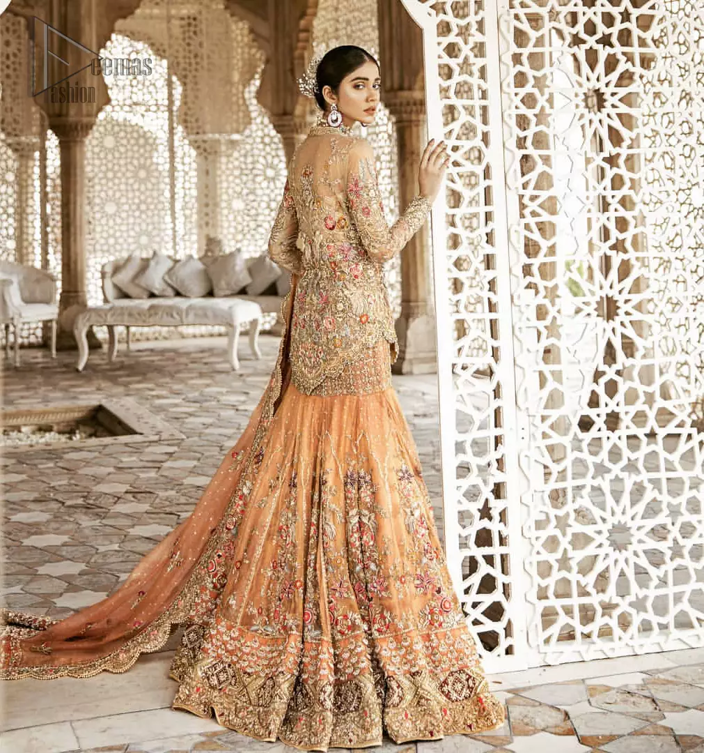 Beautifully elegant with a modern twist. Adorned in an orange embellished with antique detailing all over, this undeniably elegant attire will elevate your style. The shirt is ornamented with antique zardozi and multiple color embroidery detailing all over and vibrant floral motifs. Furthermore the hemline of the shirt is in cutwork style which adds twist. Paired it up with heavily embellished lehenga. The dupatta incorporates beautifully designed scalloped borders on all four sides, focusing on the heavily embellished pallu borders to give it a perfect look.