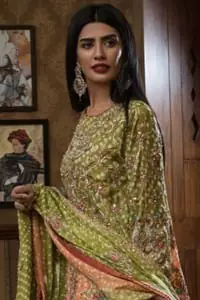 Brighten up your look with this beautiful mehndi dress comes with a beautiful parrot green shirt. This shirt is adorned with light gold kora, dabka, tilla and sequins work, furthermore the hemline is enhanced with applique embellishment. Paired it up with traditional jamawar gharara ornamented with zardozi work and finished with lace embellished border. It is coordinated with parrot green dupatta dyed from pallu in two colors and adorned with applique embellished border.