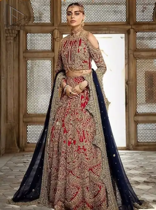 A breathtaking red traditional lehenga paired with a detailed blouse, equally alluring make for an ensemble which is comfortably chic.