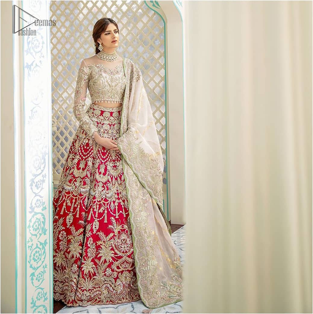 This elegant ensemble turns timeless piece into a chic fantasy. Best choice for your wedding day. This outfit is enhanced with hand embellishments on bodice and sleeves finishing with dangling tassels on the blouse. The lehenga is an amalgamation of a variety of our signature motifs, fine materials, and traditional yet contemporary silhouettes. Crafted from the prettiest zardozi work. Paired it up with off white self fabric dupatta having four sided embroidered border. 