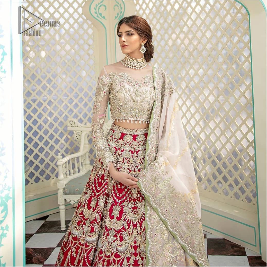 This elegant ensemble turns timeless piece into a chic fantasy. Best choice for your wedding day. This outfit is enhanced with hand embellishments on bodice and sleeves finishing with dangling tassels on the blouse. The lehenga is an amalgamation of a variety of our signature motifs, fine materials, and traditional yet contemporary silhouettes. Crafted from the prettiest zardozi work. Paired it up with off white self fabric dupatta having four sided embroidered border. 