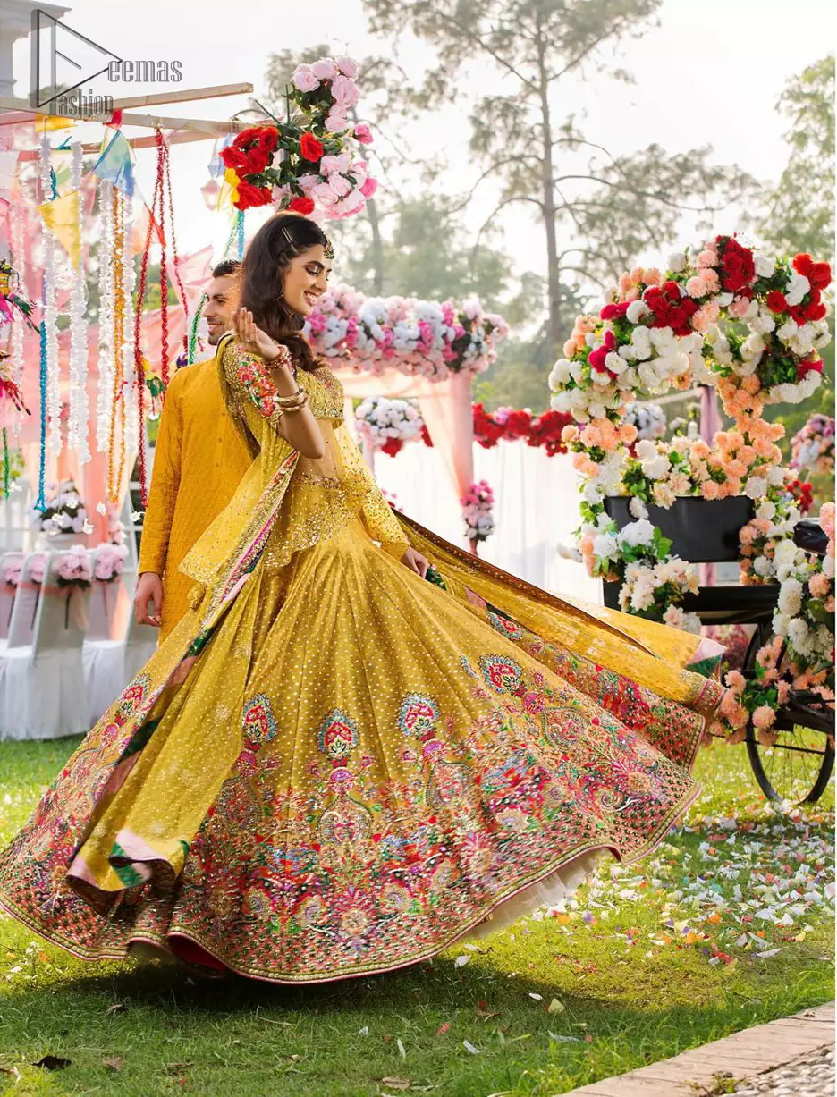 The perfect choice for Mahendi. Delicately crafted and personifying chic elegance with an element of grandiose. The shirt is emphasized with traditional neckline and a small back train. And the lehenga is decorated with intricate floral daaman enhanced with multiple color thread embroidery and rich zardozi work. Paired it up with yellow net dupatta sprinkled with sequins on the ground and four sided applique border.